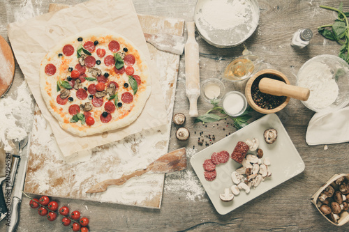 Top view cooking pizza with...