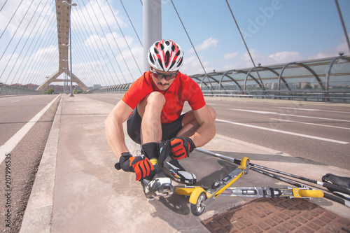 A young man cross-country skiing with roller ski photo