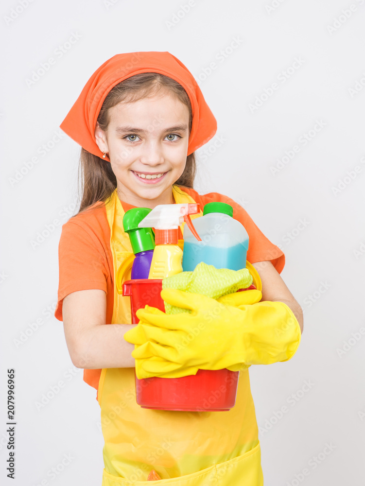 Little girl with cleaning supplies in bucket standing on white background Little girl with cleaning supplies in bucket standing on white background