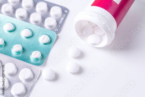 Pills from bottle on the white background