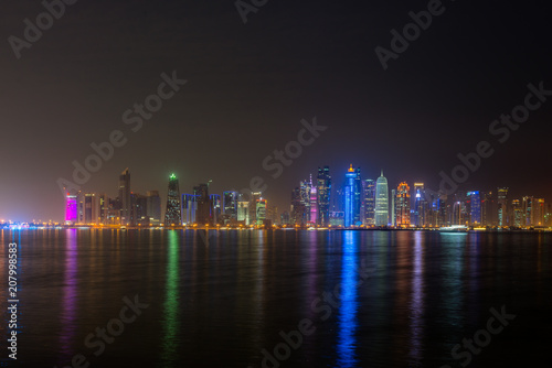 doha night city reflecting in water of persian gulf