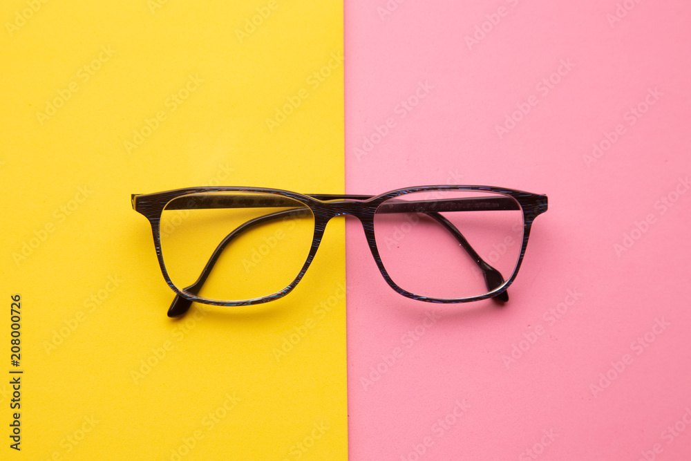 graduated glasses on colorful background