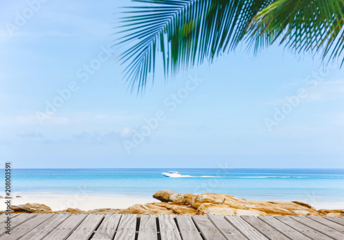 Old empty wooden pier perspective with sandy beach.Sand beach and Beautiful sea background in summer.