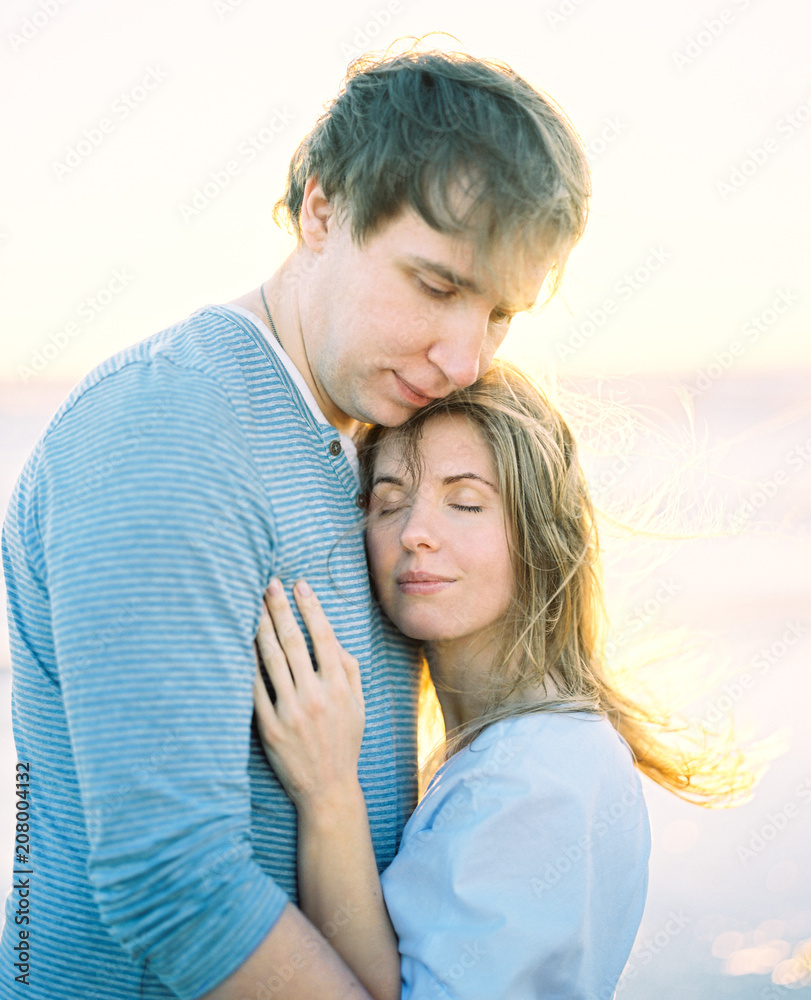 Couple standing together on meadow Couple standing together on meadow