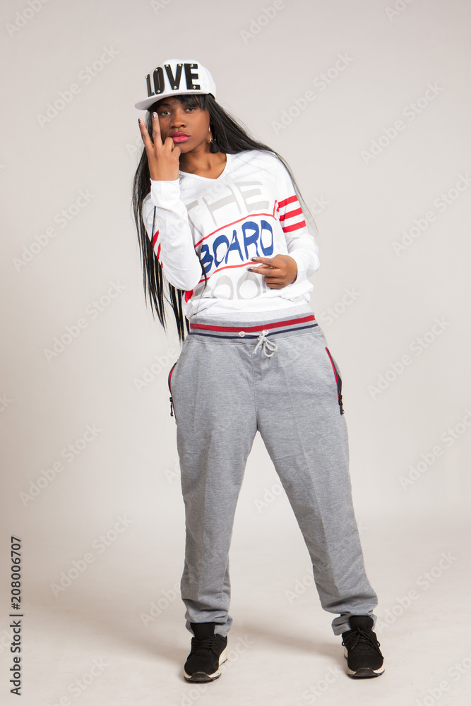 Girl with gifts. The girl is a black model. African girl in the style of HIP  HOP. Black fashion model. African American. Black girl shows gestures with  fingers. Stock Photo | Adobe