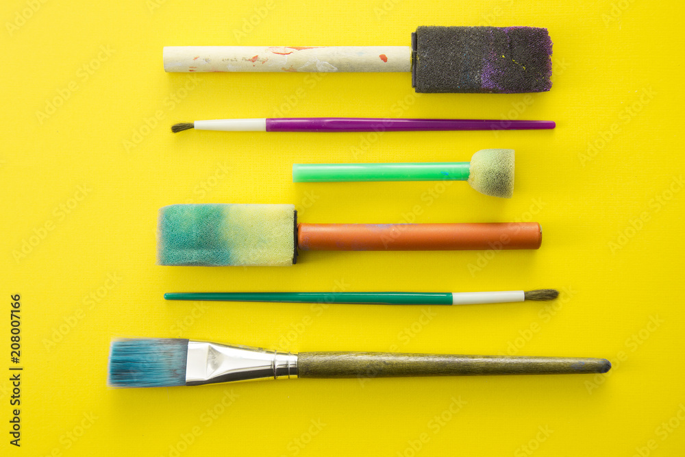 Fototapeta premium Children's Paint Brushes on a Yellow Background