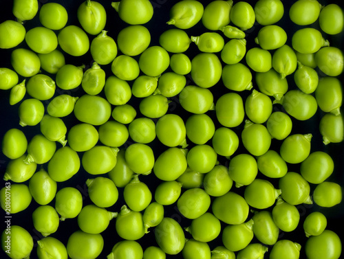 Texture and background of green peas on a black background © i_valentin