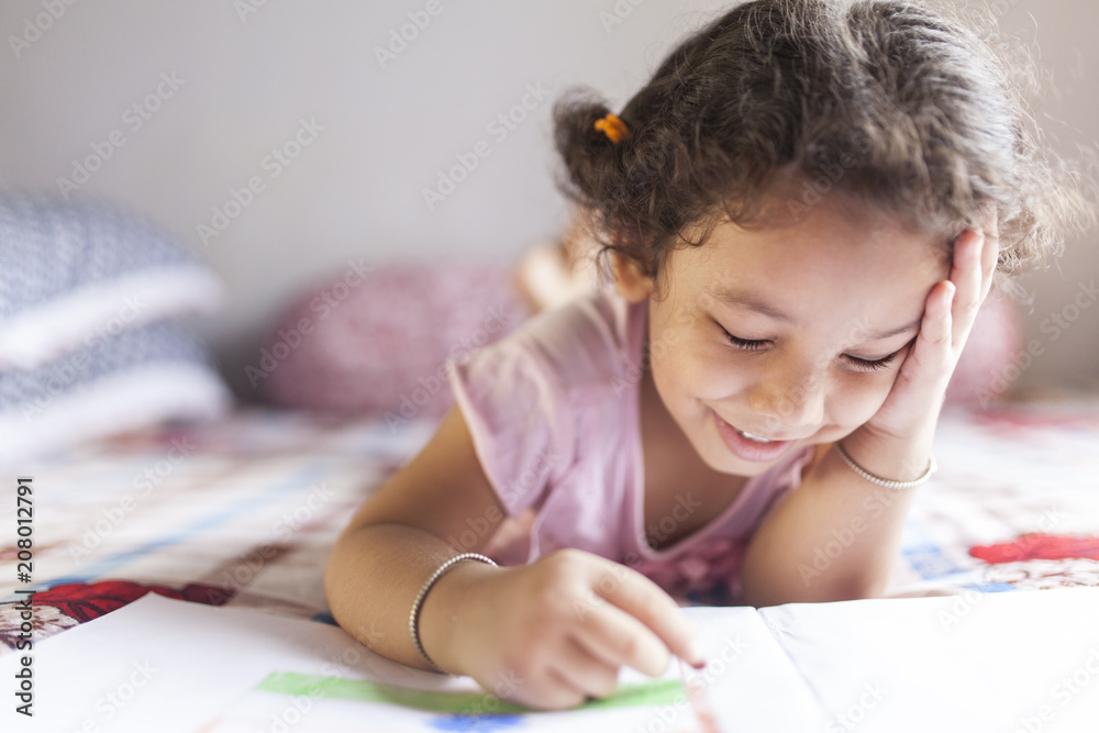 Cute kid making sketch with wax pencils and making fun Cute kid making sketch with wax pencils and making fun