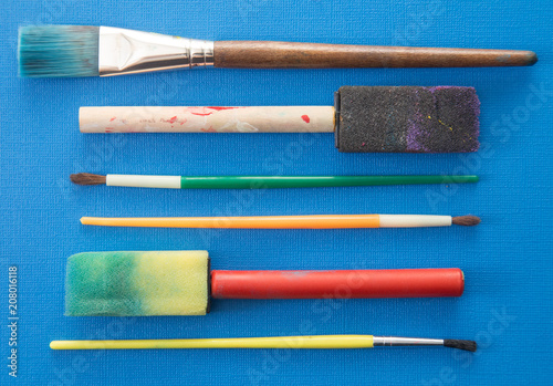 Children's Paint Brushes on a Blue Background