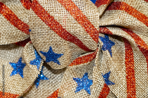Blue stars and red strips on burlap - Closeup of center of bow - background