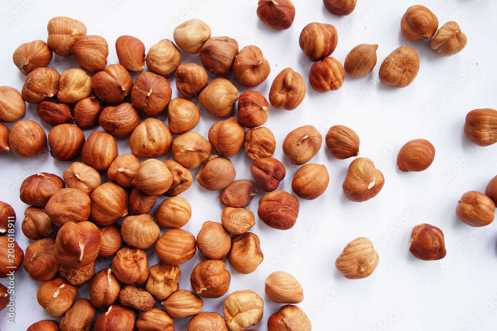 scattered hazelnuts on a white background scattered hazelnuts on a white background
