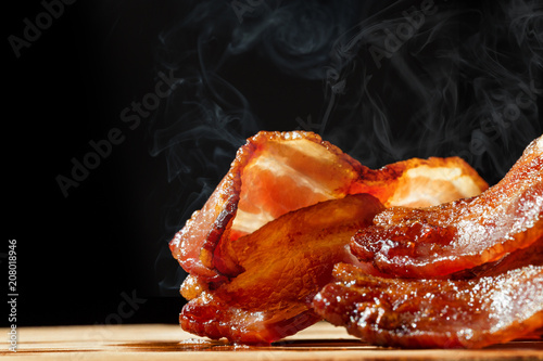 Hot Bacon With Steam Isolated on Black photo