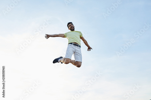 Wallpaper Mural Happy man jumping over sky. Torontodigital.ca