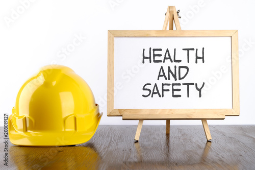 Safety helmet and white board with words Health and Safety,Health and Safety concept.