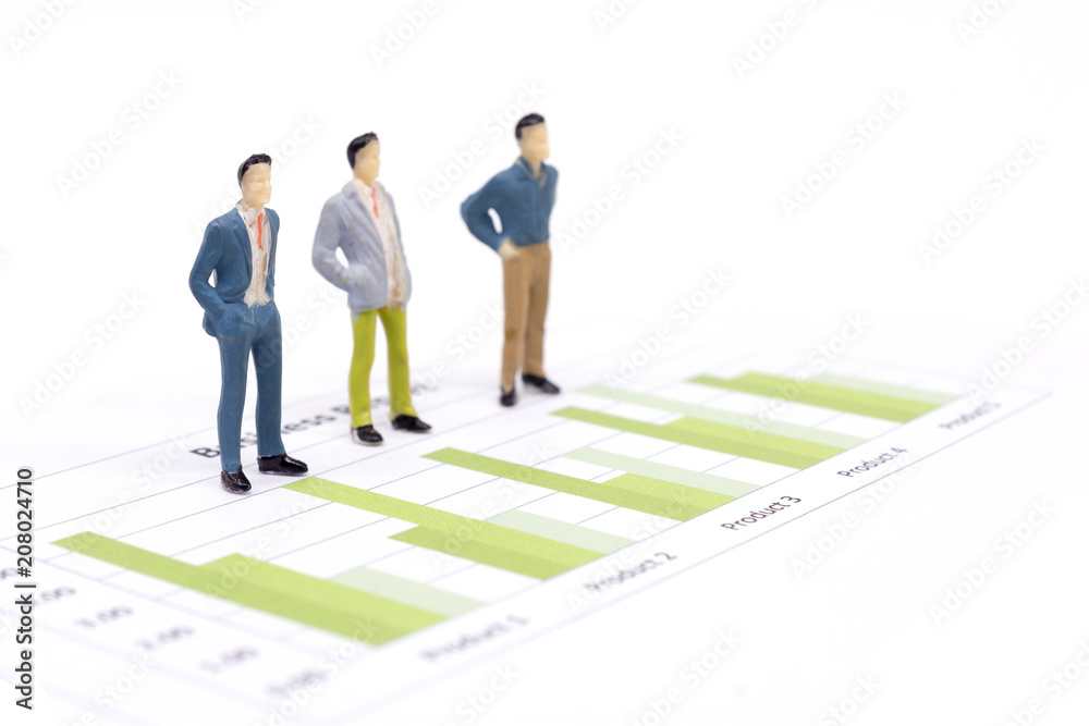 Miniature figures businessmen standing on a graph chart financial Miniature figures businessmen standing on a graph chart financial
