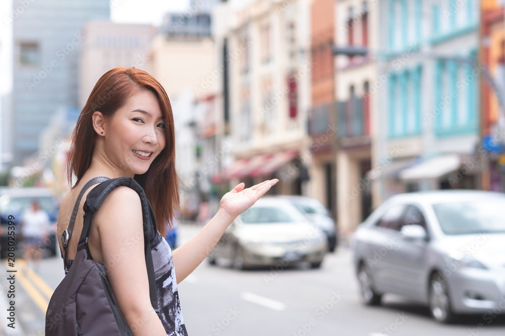 Young asian woman with smiling, enjoy her travel in Singapore China town area
