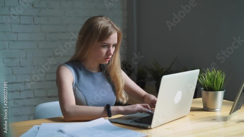 The woman was tired to work at the laptop. Headache.