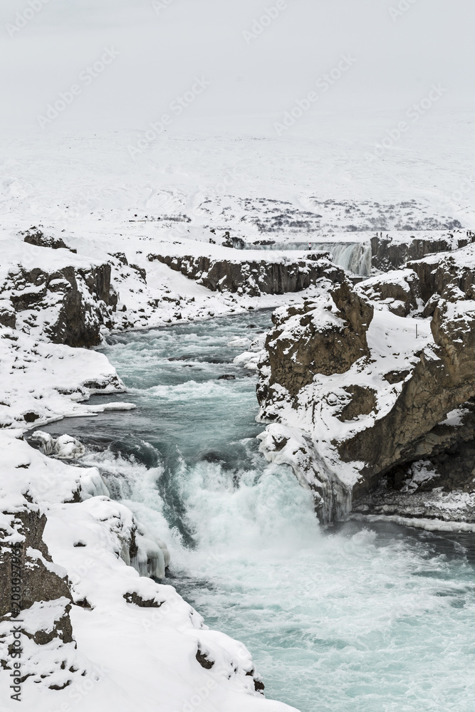 Icy waters flow from Godafoss, Northern Iceland Icy waters flow from Godafoss, Northern Iceland