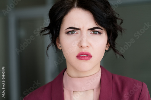 emotion face. concerned puzzled confused woman. young beautiful brunette girl portrait