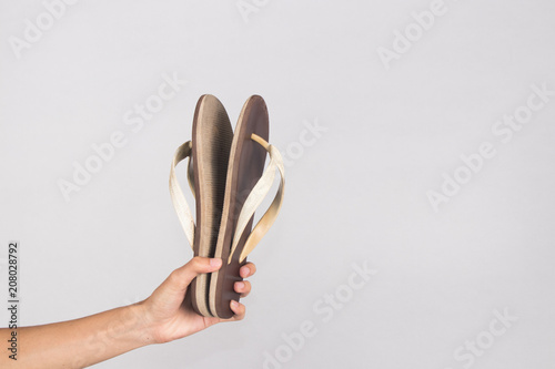 holding sandals isolated background photo