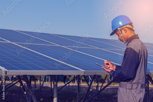 engineer working on checking and maintenance structure and solar panel and find problem to operate at green energy solar power plant