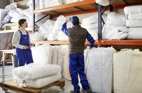 Supervisor Discussing Over Mattresses With Worker At Sofa Worksh photo