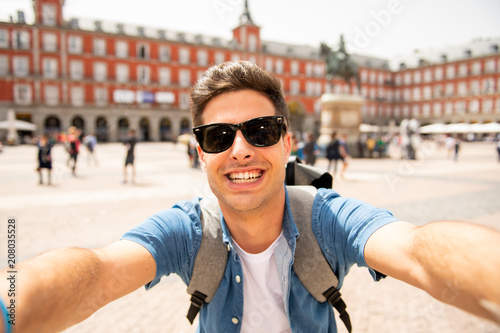 Handsome young caucasian tourist man happy and excited taking a selfie in Plaza Mayor, Madrid Spain © SB Arts Media
