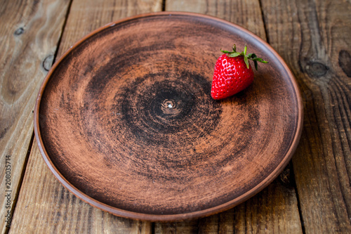 ripe juicy red strawberry on a plate photo