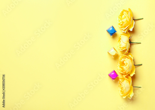 Nail polish bottle and yellow roses