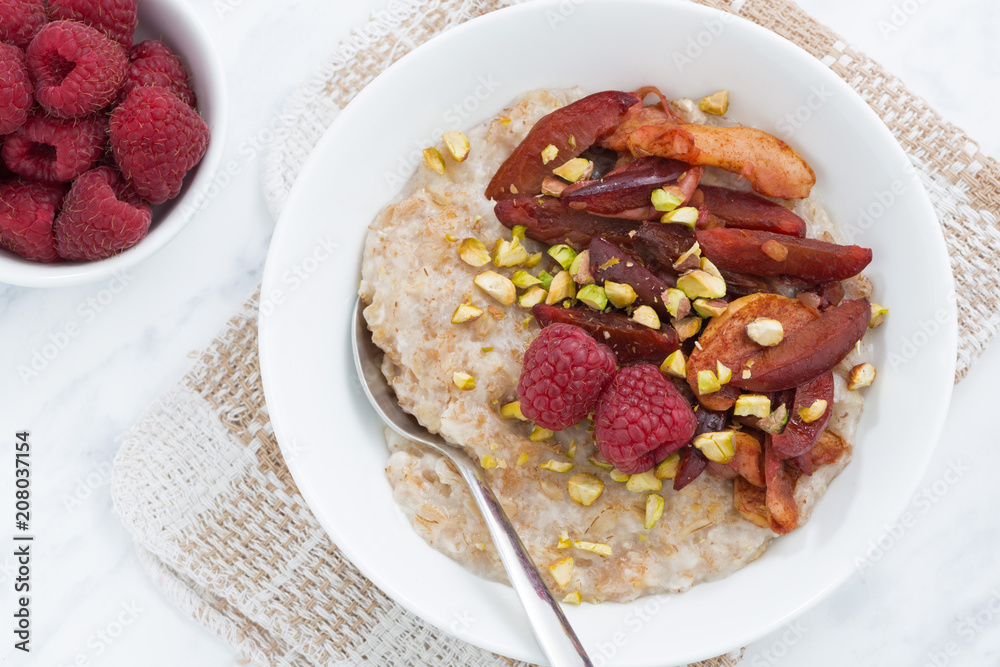 oatmeal with baked fruit for breakfast, closeup, top view oatmeal with baked fruit for breakfast, closeup, top view