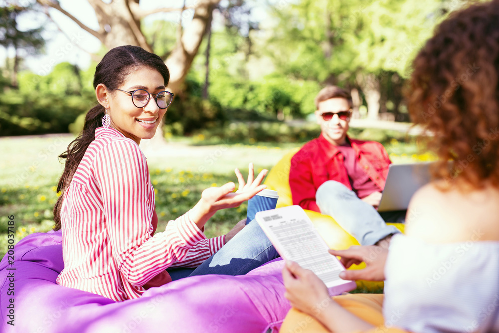 Our project. Inspired ambitious colleagues sitting in the open air and working on the project Our project. Inspired ambitious colleagues sitting in the open air and working on the project
