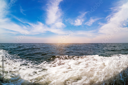Fototapeta Naklejka Na Ścianę i Meble -  White wave and tropical sea with sunset and blue sky