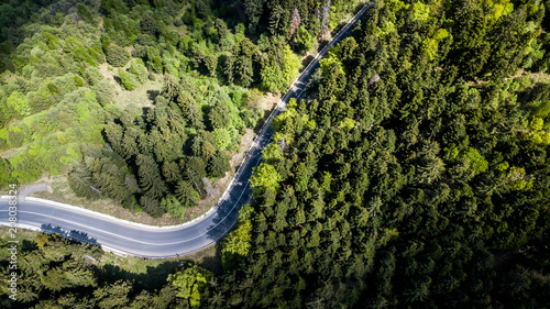Winding road from high mountain pass, in spring time. Aerial view by drone . Romania