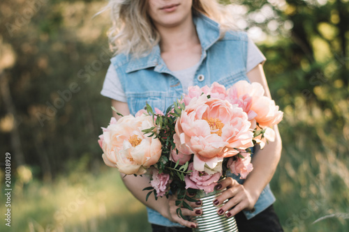 Florist woman with peony flowers