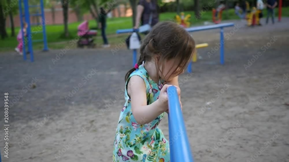 Active little child girl play on park playground running with a carousel slow motion Active little child girl play on park playground running with a carousel slow motion