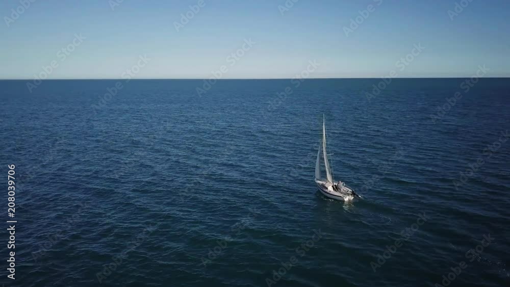 Lonely sailboat plows the expance of the ocean, aerial shoot. Yacht from drone. Lonely sailboat plows the expance of the ocean, aerial shoot. Yacht from drone.