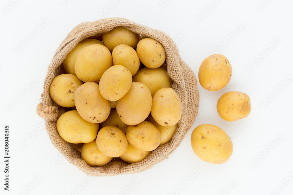 Sack of fresh raw potatoes on wooden background, top view Sack of fresh raw potatoes on wooden background, top view