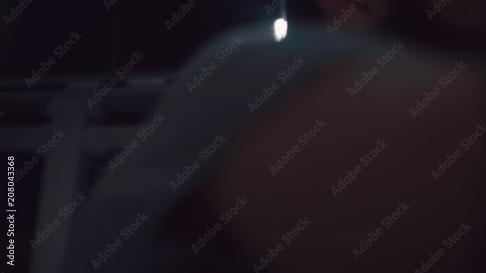 Brutal man with a beard is powerful and vigorously engaged in sports on a rowing machine. Shot on a dark isolated background. Portrait of a person during a hard sport. Exercise on the simulator. Brutal man with a beard is powerful and vigorously engaged in sports on a rowing machine. Shot on a dark isolated background. Portrait of a person during a hard sport. Exercise on the simulator.