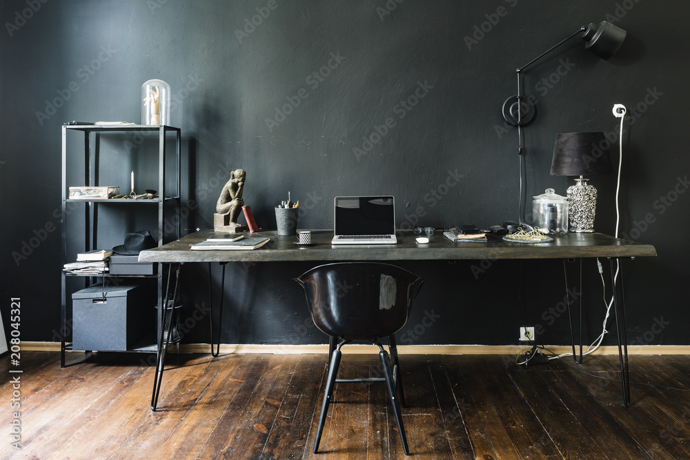 © Aleksandar Novoselski/Stocksy - Dark home office with black walls
