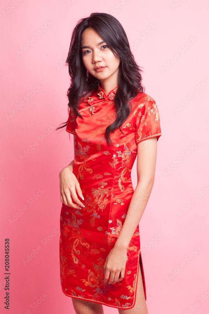 Cute Asian girl in chinese red cheongsam dress Cute Asian girl in chinese red cheongsam dress