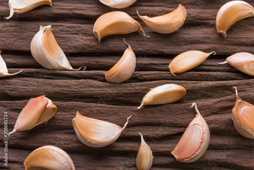 Garlic cloves on wooden vintage background.