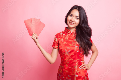 Cute Asian girl in chinese red cheongsam dress with red envelope photo