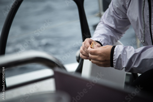 A man in the sea holds a piece of uneaten bread.