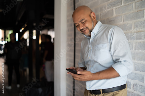 an indian man is using his smartphone
