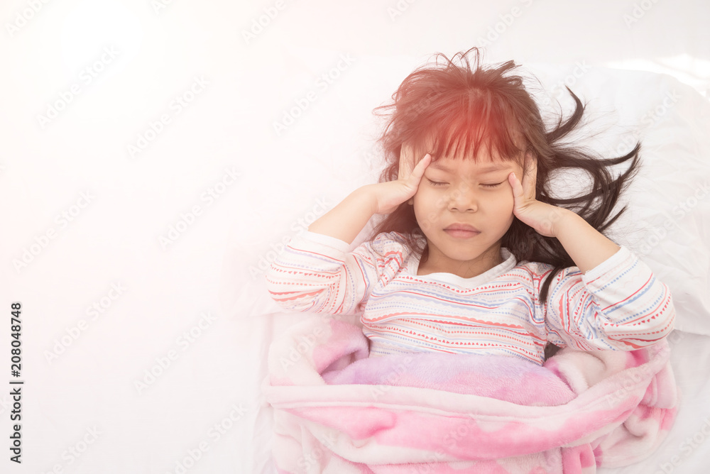 Children headache. Little girl lying in the bed Children headache. Little girl lying in the bed