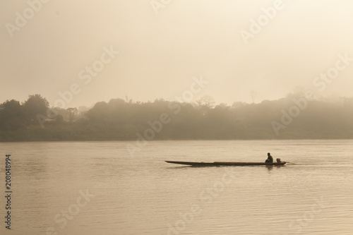 The fisherman sails the boat in the sea