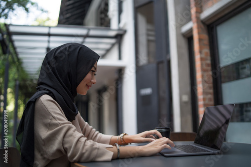 a muslim girl is doing some work