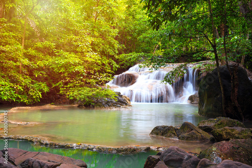 Waterfall in forest with sunlight at Erawan waterfall National Park, Kanchanaburi, Thailand