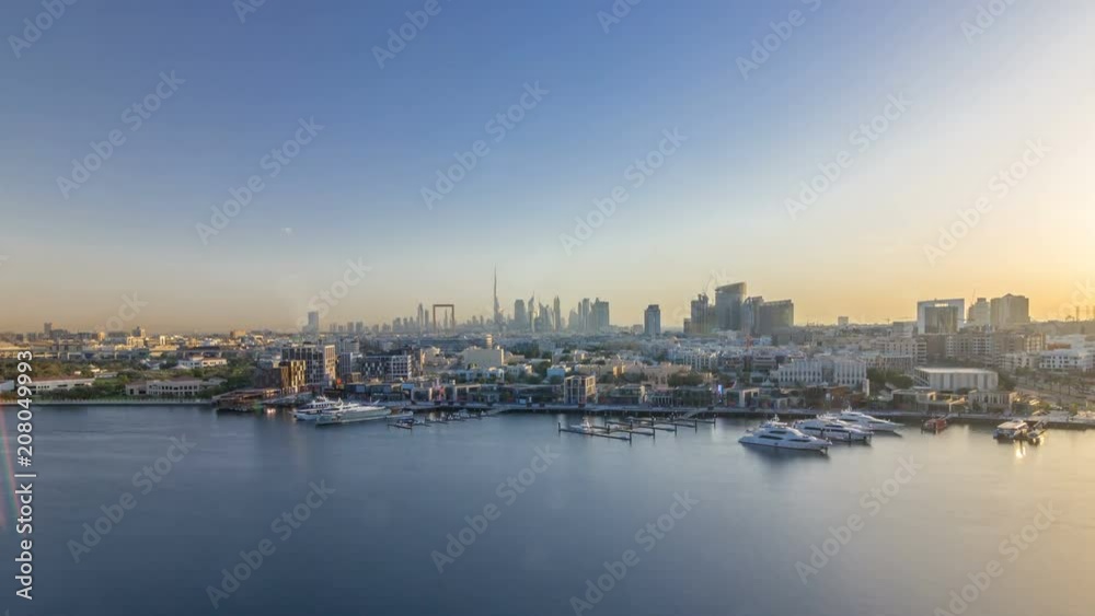 Dubai creek landscape timelapse with boats and ship and modern buildings in the background during sunset Dubai creek landscape timelapse with boats and ship and modern buildings in the background during sunset