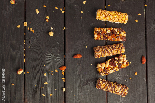 Healthy bars with nuts, seeds and dried fruits on the wooden table